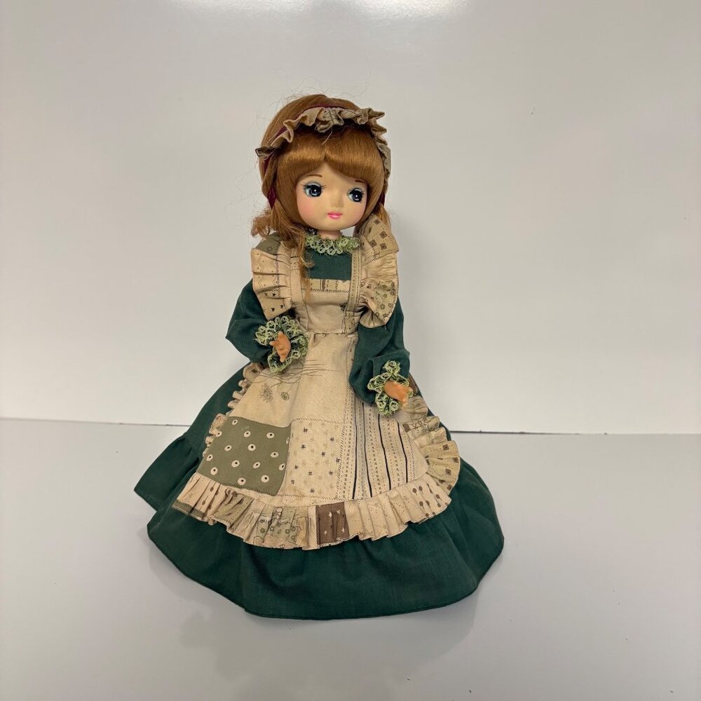 Vintage Big Eyed Doll Green Dress and Apron Musical Wooden Base 908